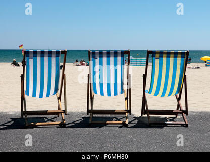 3 Leere Liegestühle in einer einheitlichen Ausbildung, während der Hitzewelle im Juni 2018, auf Sandbänke Strand, Poole, Dorset, Großbritannien Stockfoto