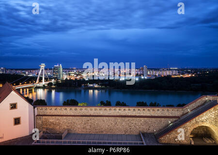 Skyline von Bratislava in der Slowakei an der blauen Stunde Dämmerung, Blick über die Burgmauer und Donau zu Stadtteil Petrzalka. Stockfoto