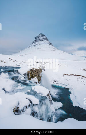 Grundafjordur, Halbinsel Snaefellsnes, Western Island, Island. Kirkjufell Berg und Kirkjufellfoss Wasserfall im Winter Stockfoto