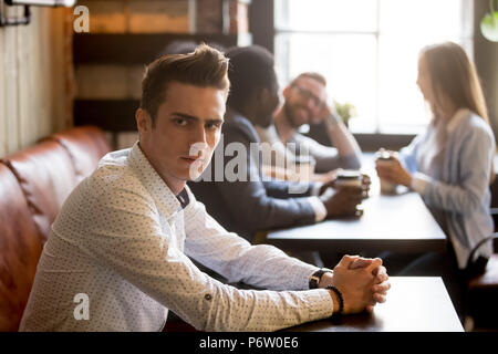 Verärgert Mann eifersüchtig auf Multirassischen Freunde Spaß haben im Cafe Stockfoto