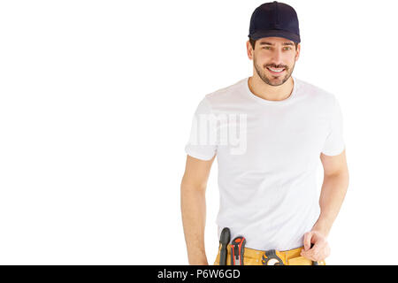 Portrait von hübscher junger Handwerker tragen Baseball Cap und Werkzeug Gürtel beim Stehen an vereinzelten weißen Hintergrund mit kopieren. Stockfoto