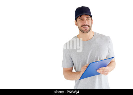 Portrait von gutaussehenden jungen Mann an vereinzelten weißen Hintergrund. Ein Lächeln auf den Lippen tragen Mann Baseballmütze und Holding Zwischenablage in seiner Hand. Stockfoto