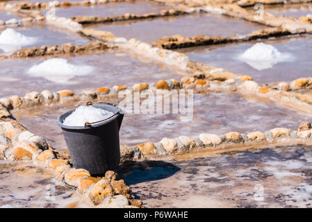 Ernte Meersalz aus dem alten Salinen in Marsalforn, Gozo, Malta. Stockfoto