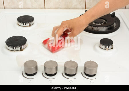 Hand der Frau Reinigung Gasherd in der Küche Stockfoto
