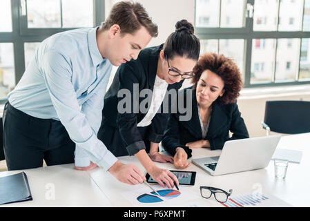 Business Experten interpretieren Kreisdiagramm auf Papier gedruckt Stockfoto