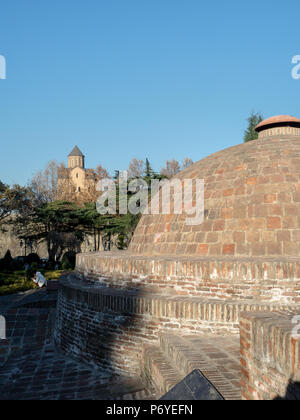 Kuppelförmige Badehaus Dach mit Metekhi Kirche im Hintergrund, abanotubani Bezirk, Tiflis, Georgien Stockfoto