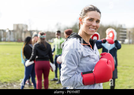 Porträt Lächeln, selbstbewusste Frau Boxen in Park Stockfoto