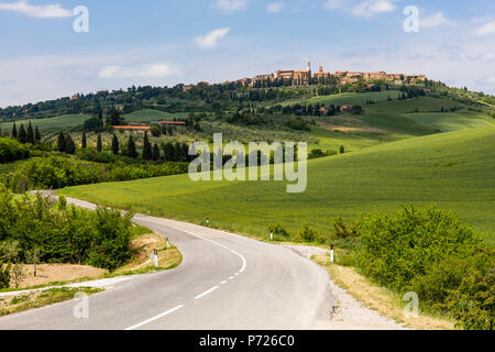 Toskanische Straße windet sich durch grüne Felder Richtung Pienza, Toskana, Italien, Europa Stockfoto