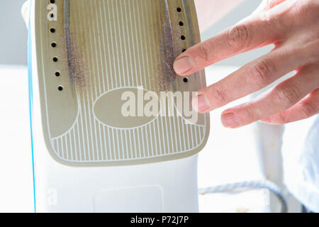 Nahaufnahme der Frau Hände prüfen Dampfbügeleisen Stockfoto