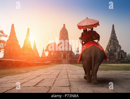 Touristen mit einem Elefanten im Wat Watthanaram Tempel in Ayutthaya Historical Park, einem UNESCO-Weltkulturerbe in Thailand Stockfoto