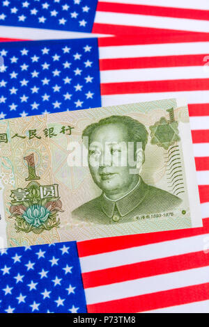 US Flag/Sterne und Streifen mit 1 Yuan Banknote - Metapher US-China trade Krieg/Handelsstreit/Trumpf Stahltarife, Chinesischer Renminbi Yuan Schwäche. Stockfoto