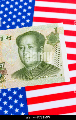 US Flag/Sterne und Streifen mit 1 Yuan Banknote - Metapher US-China trade Krieg/Handelsstreit/Trumpf Stahltarife, Chinesischer Renminbi Yuan Schwäche. Stockfoto