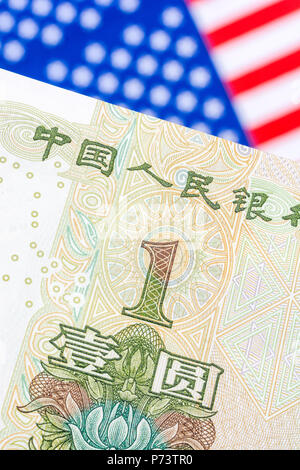 US Flag/Sterne und Streifen mit 1 Yuan Banknote - Metapher US-China trade Krieg/Handelsstreit/Trumpf Stahltarife, Chinesischer Renminbi Yuan Schwäche. Stockfoto