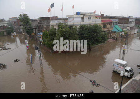 Pakistanische Einwohner von China Regelung durch Überflutete Straße nach dem heftigen Monsunregen in Lahore. Die laufenden vormonsun Regen spell hat wieder einmal schlagen die Stadt. Mindestens 6 Menschen wurden getötet, viele im Regen - Vorfälle verletzt. Gnadenlos als 238 mm Regen weitere drei Stunden den größten Teil der Stadt, die sich in den schlimmsten Staus sowie ernsthafte Unannehmlichkeiten für die Bürger überschwemmt. Das Met Office hat gesagt, dass aufgrund der hohen Druck Monsun Ströme durchdringen im Land, die Punjab Hauptstadt sowie anderen Städten, weiterhin Regen für die nächsten zwei zu erhalten d Stockfoto