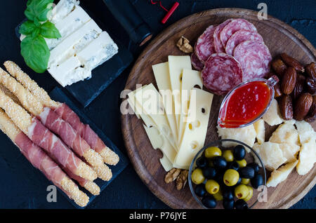 Tabelle mit mediterranen Vorspeisen, Tapas und Antipasti. Verschiedene italienische Küche. Leckerer Snack auf Party oder Picknick. Schneidbrett mit mir Stockfoto