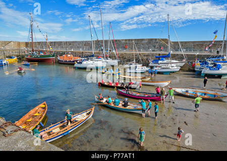 PORTSOY FESTIVAL ABERDEENSHIRE SCOTLAND REGATTEN MANNSCHAFTEN VORBEREITUNG UND EINLEITUNG BOOTE AUS DEM HAFEN STRAND Stockfoto