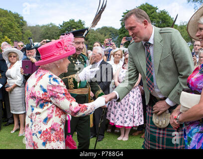 Queen Elizabeth II trifft ehemalige Schottland ruby player Doddie Wehr während einer Gartenparty am Palast von Holyroodhouse in Edinburgh. Stockfoto