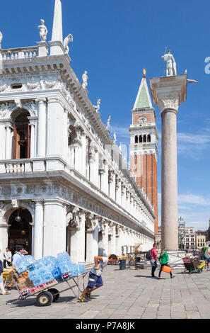 Arbeitnehmer Ziehen einer Trolley mit Wasserflaschen in Piazetta San Marco, Venedig, Italien hinter dem Marciana Bibliothek. Venezianischen Alltag Stockfoto