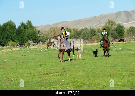 Zwei kasachische Fahrer in traditioneller Kleidung, Sati Dorf, Tien-Shan-Gebirge, Kasachstan Stockfoto