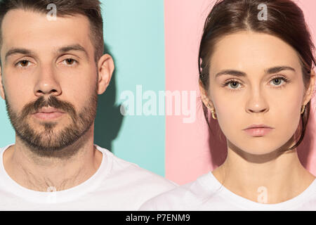 Die ernsten Mann und Frau an der Kamera gegen Rosa und blauem Hintergrund. Stockfoto