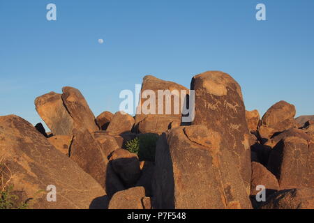 Aufgehenden Mond hinter Felsen mit Hohokam Felszeichnungen auf dem Signal Hill im Saguaro National Park in der Nähe von Tucson, Arizona, USA. Stockfoto