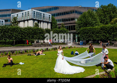 Ein Besuch Braut aus Hong Kong stellt für Hochzeit Fotografie auf dem Rasen außerhalb St Paul's Cathedral, London, England Stockfoto