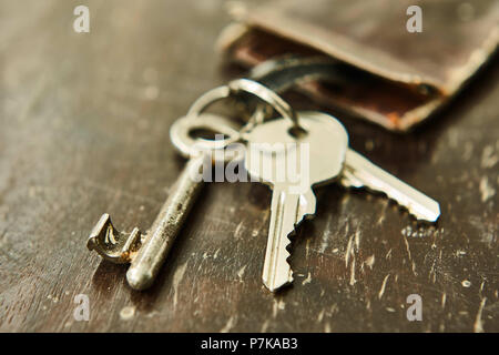 Schlüsselanhänger mit Ledertasche auf Holz Stockfoto