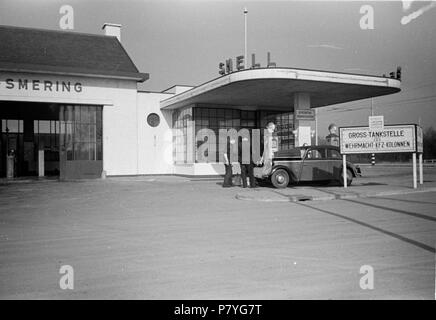 . Huizinga collectie afbraak stadsdelen - Niod-216508. Nederlands: Foto uit de collectie Huizinga van het NIOD. Een personenauto Staat bij een door de Duitse bezetter gelegalizeerd benzinestation. Menno Huizinga war onderdeel van de Ondergedoken Kamera en-de illegaal maakte Foto tijdens bezetting. Dit tat hij zijn woonplaats hoofdzakelijk in Den Haag. Datum unbekannt 37 BC856 HUI-1201 Stockfoto