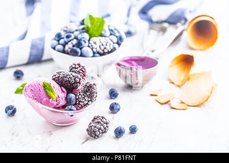 Blueberry und Black Ice Cream in Schüssel mit gefrorenen Früchten. Stockfoto