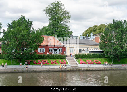 TURKU, FINNLAND - 8/7/2018: Zeichen von Turku von Blumen in Finnisch und Schwedisch geschrieben von der Aura Fluss und Apotheke Museum im alten Gebäude aus Holz Stockfoto