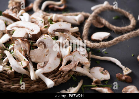 Nahaufnahme von einem Stapel von Raw gemischte Pilze, wie z. B. gemeinsame Champignons, Austernpilze und Shiitake, auf einem grauen rustikalen Holztisch Stockfoto