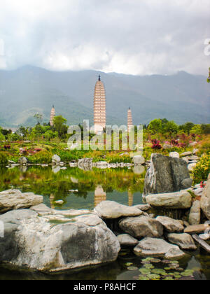 Die drei Pagode der Tempel Chongsheng in Dali im Frühjahr mit stürmischem Wetter in den Teich wider Stockfoto