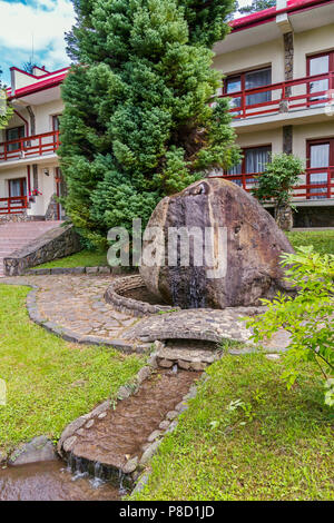 Schönen Brunnen mit einem großen Stein im Hof des Hotels in den Bergen. Für ihr Design Stockfoto