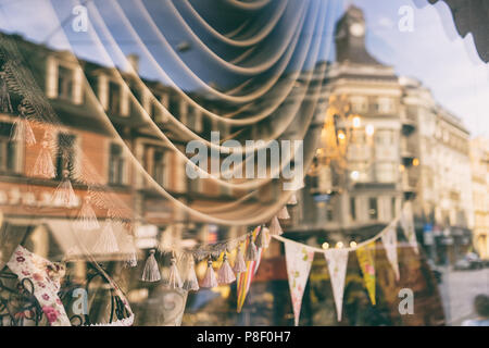 Gebäude in der Altstadt von Riga sind im Shop Fenster mit Vorhängen und Flaggen mit Spielzeug wider Stockfoto