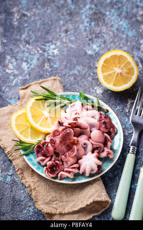 Tintenfische in der Platte mit Zitrone und Rosmarin Stockfoto