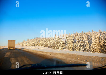 winter road in the mountains. The truck travels along the road Stockfoto