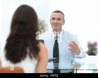 Business Consultant sitzt an seinem Schreibtisch und mit ihren Kunden beraten Stockfoto