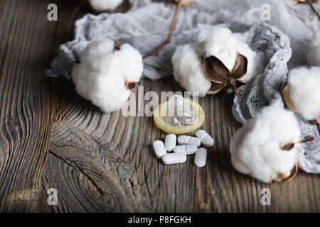 Pille und Kondom auf eine Holz- Oberfläche. Nahaufnahme Stockfoto