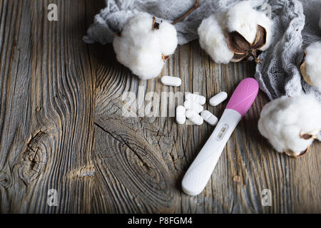 Pille und Kondom auf eine Holz- Oberfläche. Closeup empfängnisverhütende Pillen und Schwangerschaft Test auf einem Holz- Oberfläche. Nahaufnahme Stockfoto