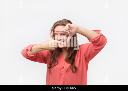 Jungen kaukasischen Frauen im roten Hemd blogger Pläne, wie Ihr neues Projekt zu schießen. Studie zu professionelle Fotos machen. Stockfoto