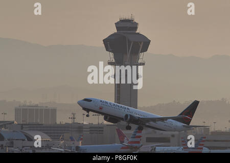 Air Canada Boeing 737 MAX. 8, Jet Airliner vom Internationalen Flughafen Los Angeles, LAX, bei Sonnenaufgang, der Tower hinter sich. Kalifornien, US. Stockfoto