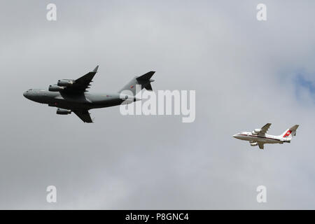 RAF Boeing C-17A Globemaster ab 99 Squadron führt eine BAe 146 ab 32 (Royal) Squadron über Ipswich während der 100 Jahre RAF Jubiläum Flypast. Stockfoto