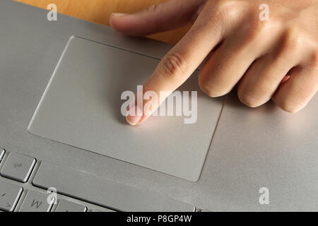 Close-up o einer Frau den Finger auf dem Touchpad eines Notebooks Computer im Büro. Stockfoto