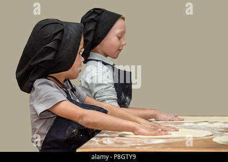 Wenig Köche lernen, wie Pizza zu backen. Master Class für Kinder Pizza zu backen. Kinder backen Pizza Bosse. Stockfoto