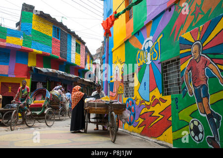 DHAKA, BANGLADESCH - Juli 10: Bangladesch Menschen Spaziergänge durch Neben einer Mauer mit Fußballfans während der FIFA WM 2018 in Russland gemalt in Dhaka Stockfoto