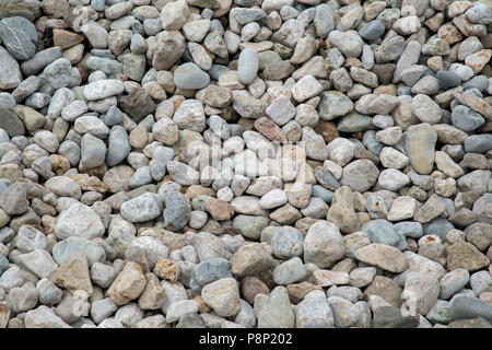 Kieselsteine am Strand shot Full Frame als Textur Hintergrund Stockfoto