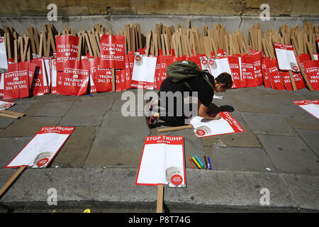 Ein Demonstrant schreibt eine Nachricht auf einem Plakat in der Nähe von Portland Place in London, als er bereitet Teil in einer Demonstration Oberseite Trumpf", in London als Teil der Proteste gegen den Besuch von US-Präsident Donald Trump nach Großbritannien. Stockfoto