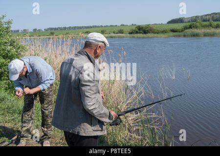 Männer Angeln am Teich genießen. Stockfoto