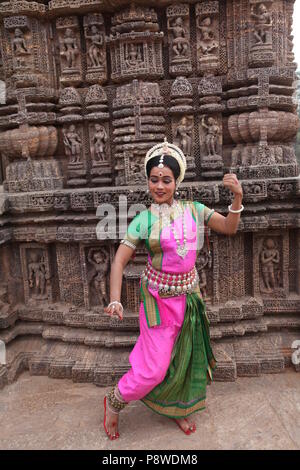 Odissi ist eines der acht klassischen Tanzformen Indiens, vom Zustand von odisha. Hier die Tänzerin stellt sich vor Tempeln mit Skulpturen Stockfoto