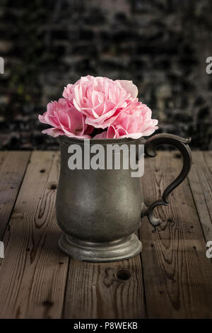 Rose in einem Zinn Becher schneiden Stockfoto